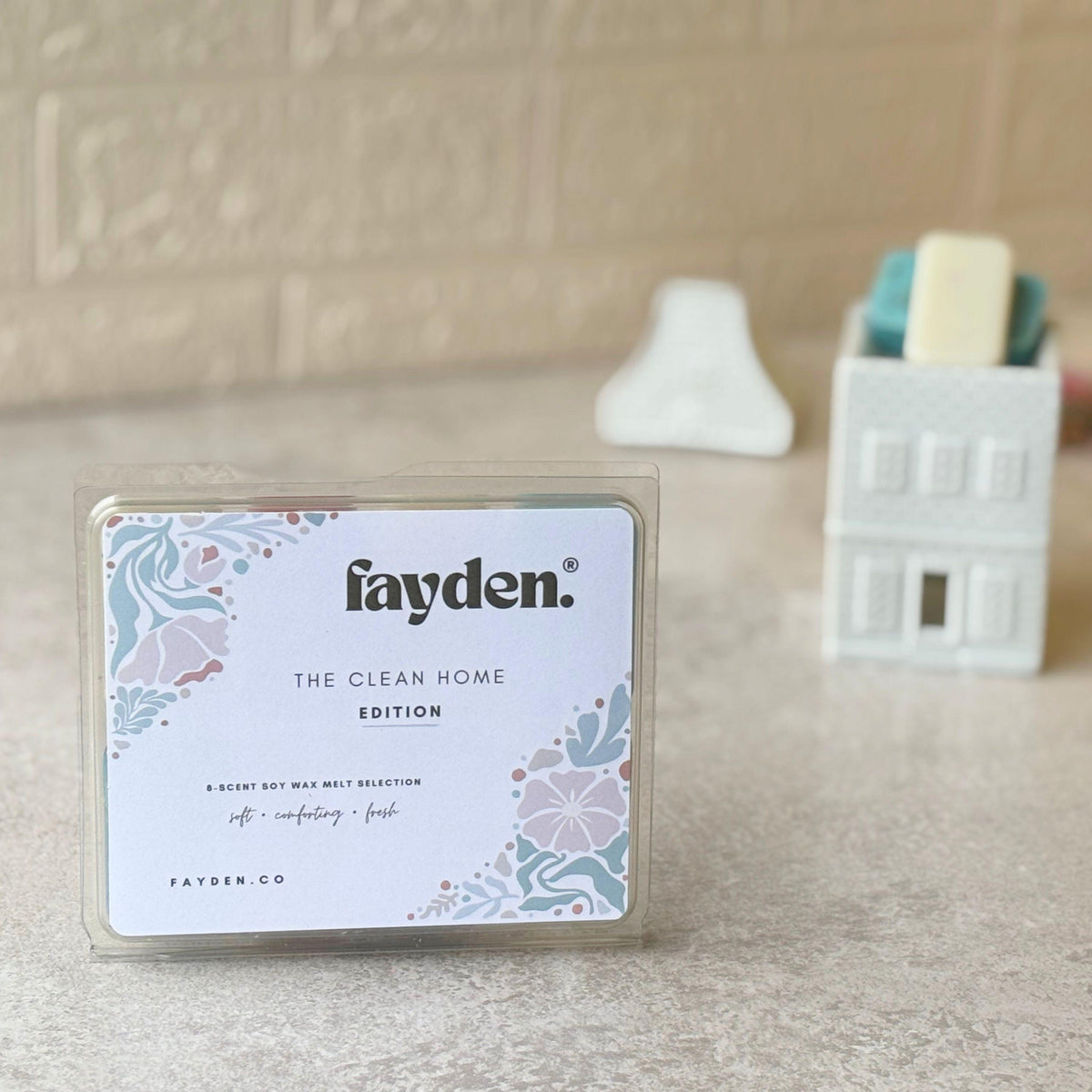 FAYDEN home fragrance scent guide featuring eight fragrances: Linen Breeze, Spring Awakening, Dreams, Marseille Soap, Clothesline, Bliss, Fresh Sea Air and Baby Powder. The elegant floral illustrated design describes each scent with notes of fresh cotton, green florals, soft woods, powdery warmth, clean air and gentle musk. A refined home fragrance collection created for quiet rituals, comforting moments and making home feel beautifully yours