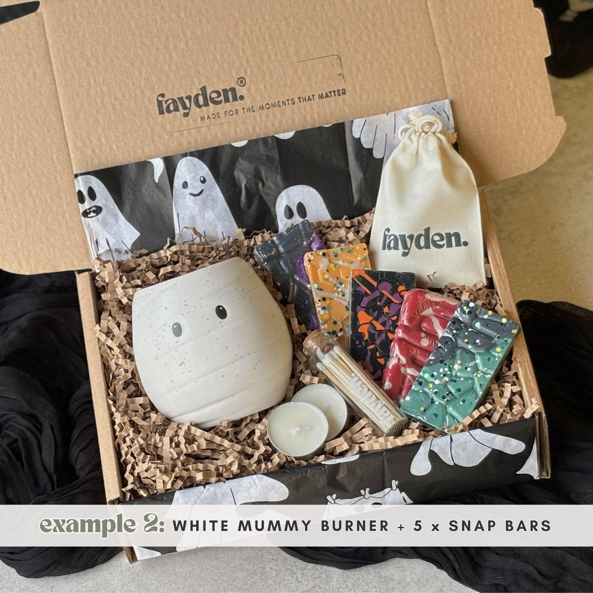 Halloween wax melt burner gift set in a spooky FAYDEN gift box, featuring an orange pumpkin burner, white mummy burner, assorted Halloween wax melts, tealights and a handmade gift-ready presentation  Halloween Wax Melts
Strong Wax Melts
Pumpkin Spice Melts
Spooky Surprise Gift
Hug In A Box Gifts
Halloween Pocket Hug
Mystery Sampler Box
Boo Basket Gift Idea
Autumn Scents
Melts Discovery Box
Build Your Own Set
Custom Halloween Box
Home Fragrance Gift